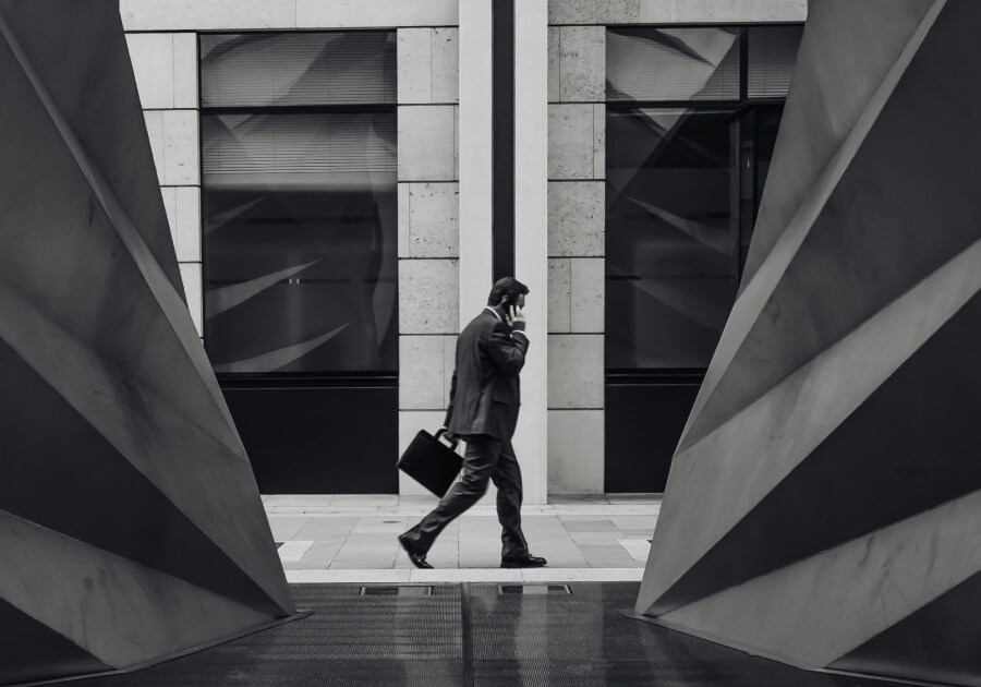Man walks past bank building